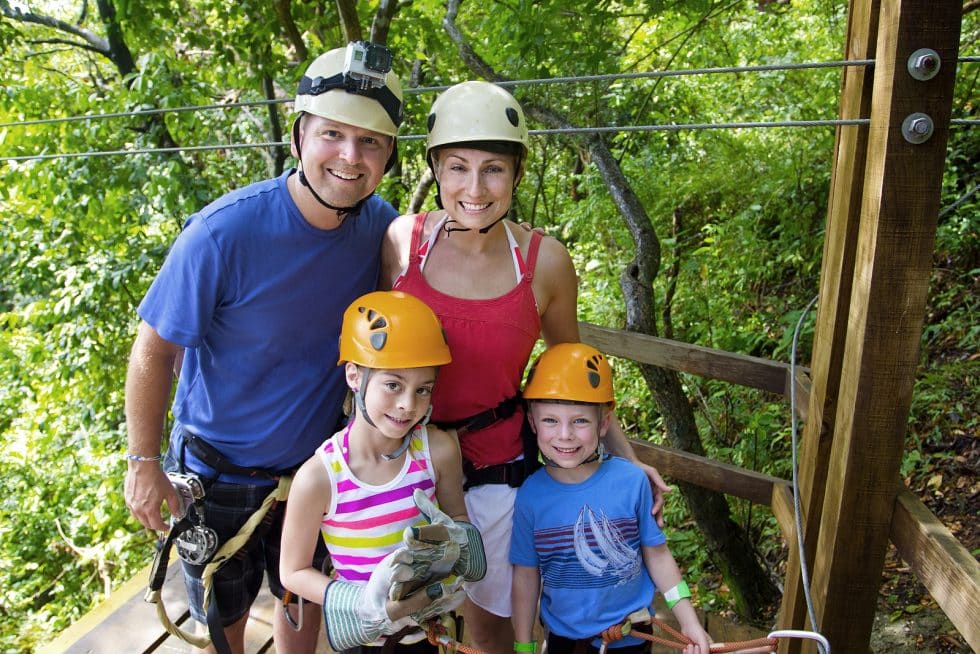 Vacation Travel Innovation Reviews family adventure image showing parents and children preparing for an outdoor activity.